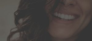 Picture of the mouth of a brown-haired woman smiling