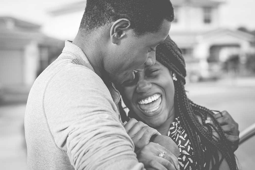 Black and white photo of a couple hugging and smiling