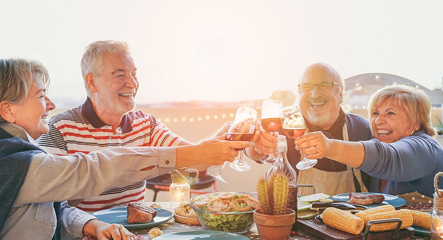 Older couples cheers at dinner
