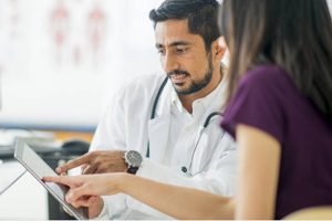 Doctor showing their tablet of the plan to patient