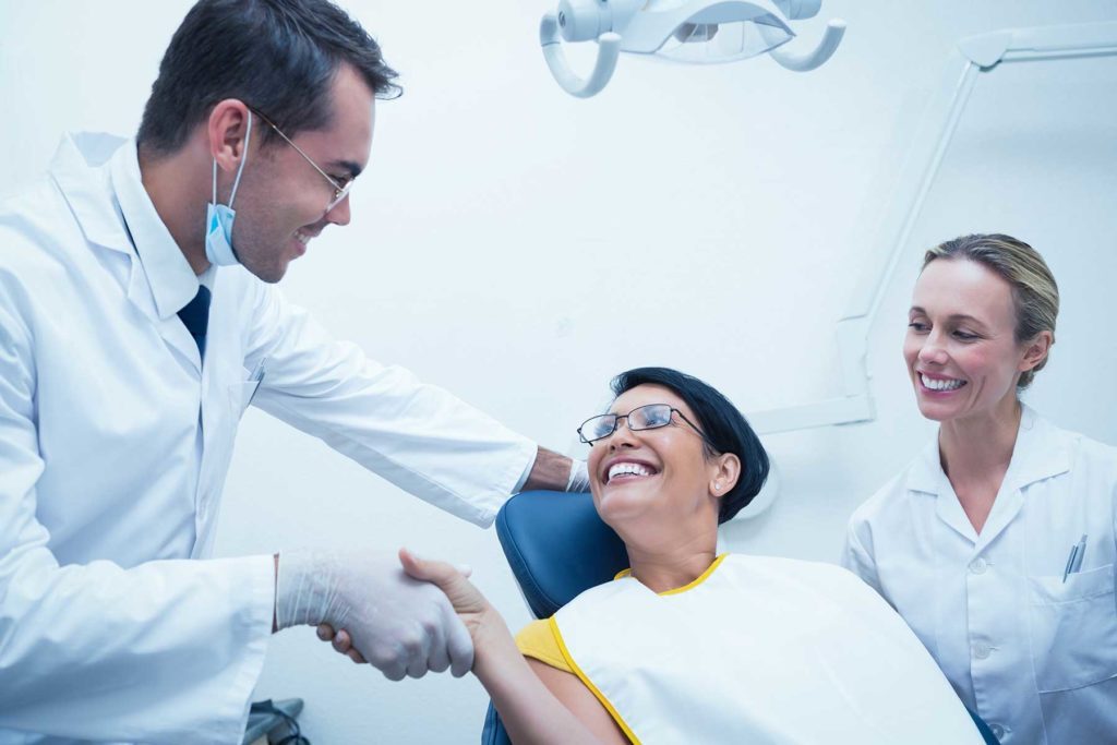 implant dentist greeting patient